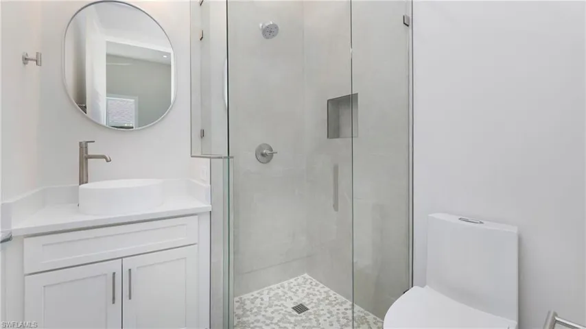 Full bath with a stall shower and vanity