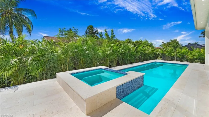 View of pool featuring a patio and a pool with connected hot tub