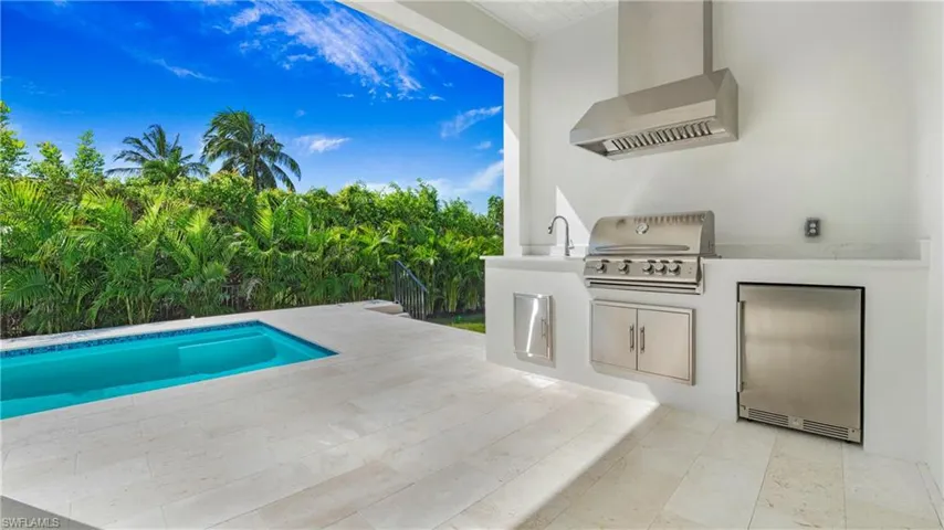 Swimming pool with area for grilling and a patio area