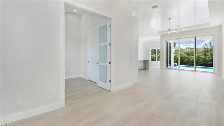 Spare room featuring a ceiling fan, light wood-style flooring, and recessed lighting