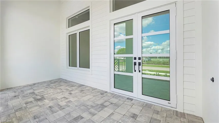Doorway to property featuring french doors and a patio area
