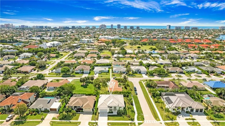 Aerial perspective of suburban area with skyline and a large body of water