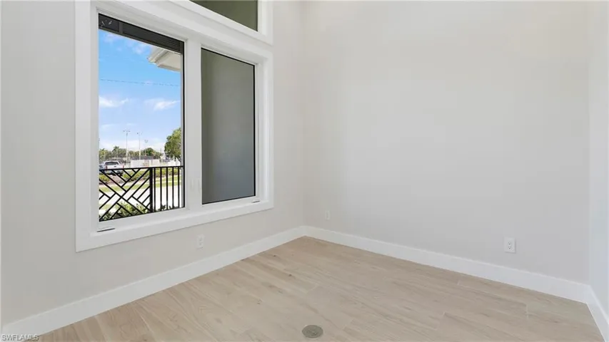 Spare room with light wood-style floors and baseboards