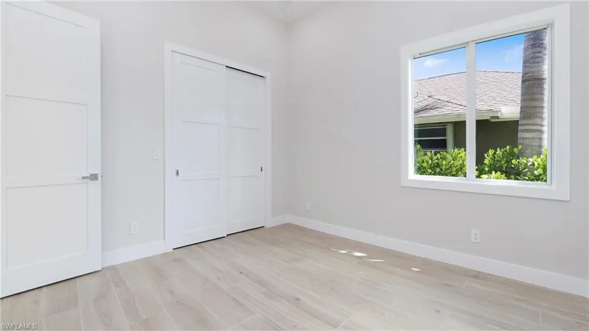 Unfurnished bedroom featuring light wood finished floors and a closet
