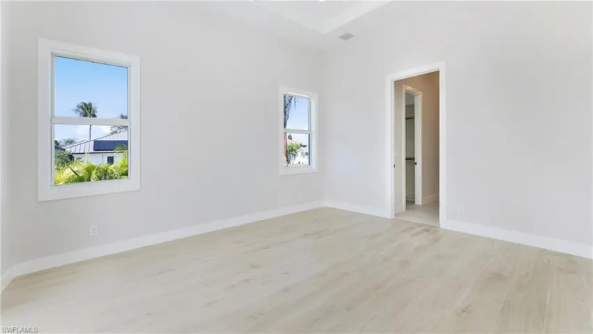 Spare room featuring light wood finished floors and baseboards