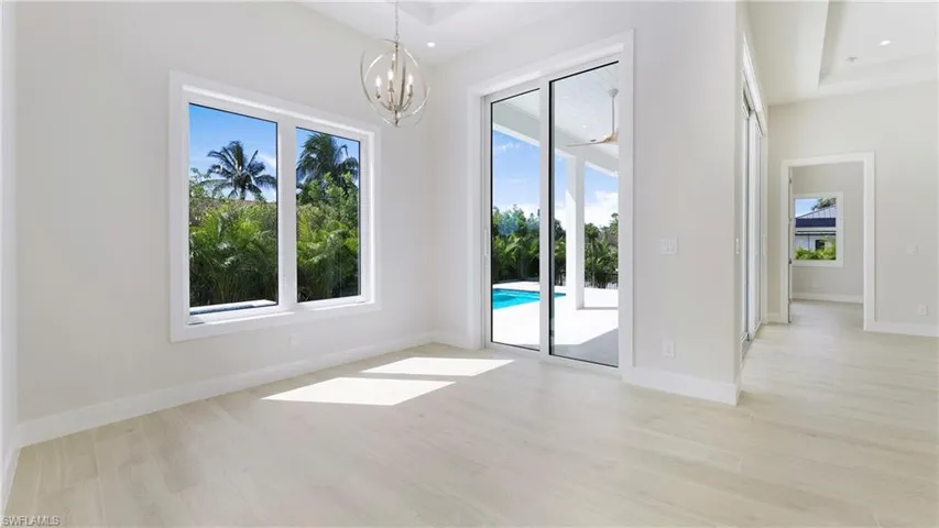 Unfurnished dining area featuring light wood-type flooring and a chandelier