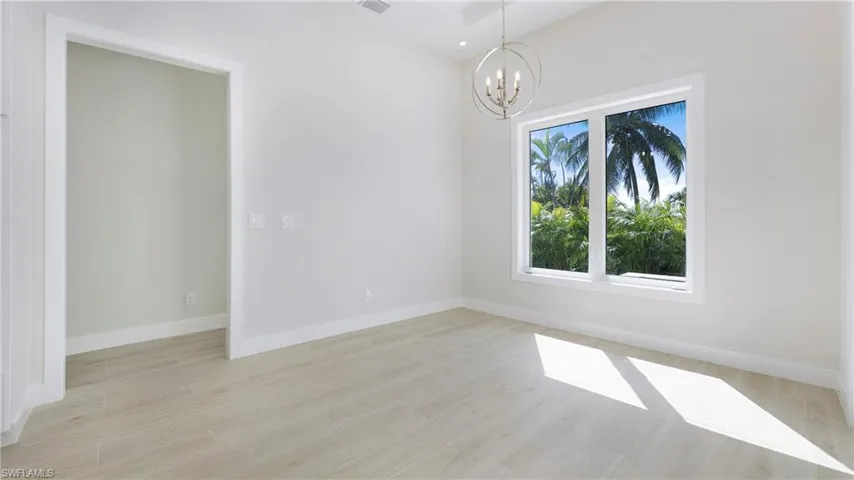 Unfurnished dining area with light wood finished floors, a chandelier, and recessed lighting