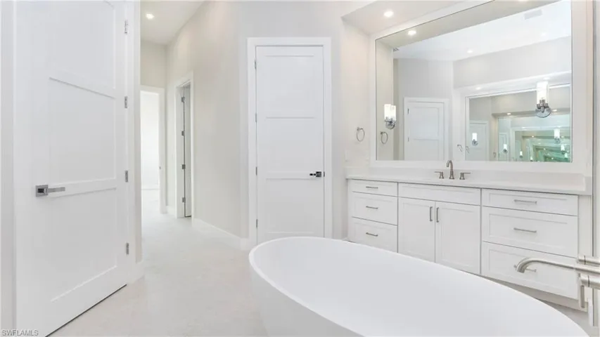 Full bath with vanity, a soaking tub, recessed lighting, and a shower stall
