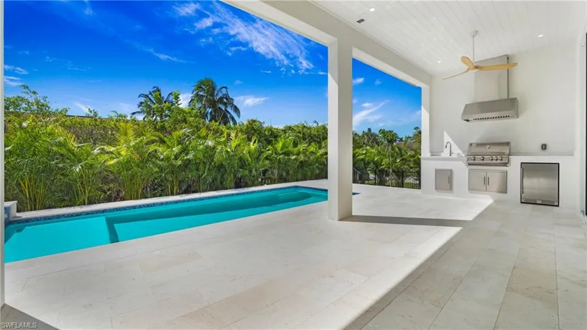 View of swimming pool featuring area for grilling