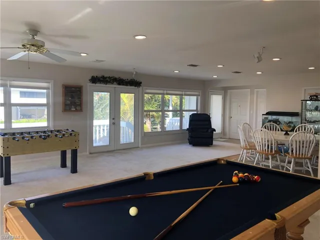 Rec room with pool table, carpet flooring, french doors, ceiling fan, and recessed lighting