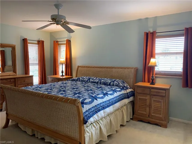 Bedroom featuring light carpet and ceiling fan