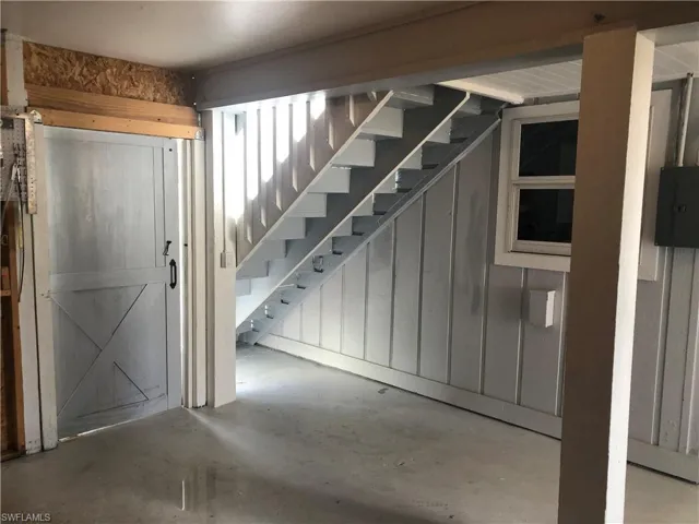 Below grade area with stairs and electric panel