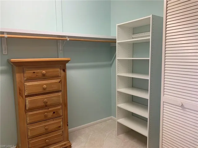 Walk in closet featuring carpet flooring