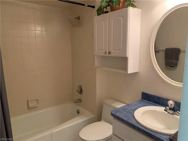 Full bath featuring shower / bath combo with shower curtain and vanity