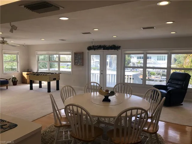 Carpeted dining space featuring recessed lighting, wood finished floors, and a ceiling fan