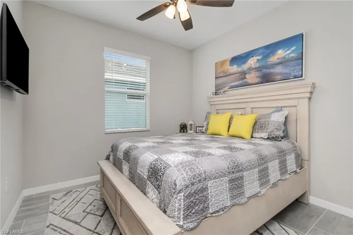 Bedroom featuring baseboards and ceiling fan