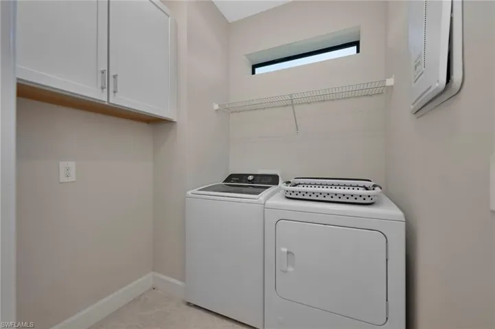 Laundry area featuring cabinet space and separate washer and dryer
