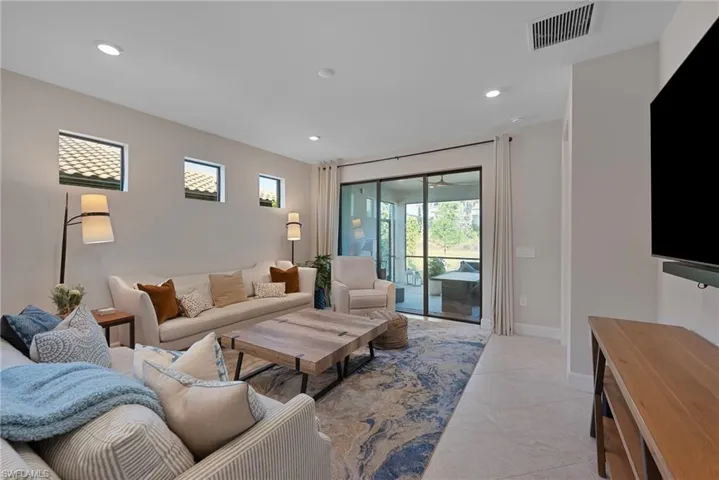Living area with recessed lighting and baseboards