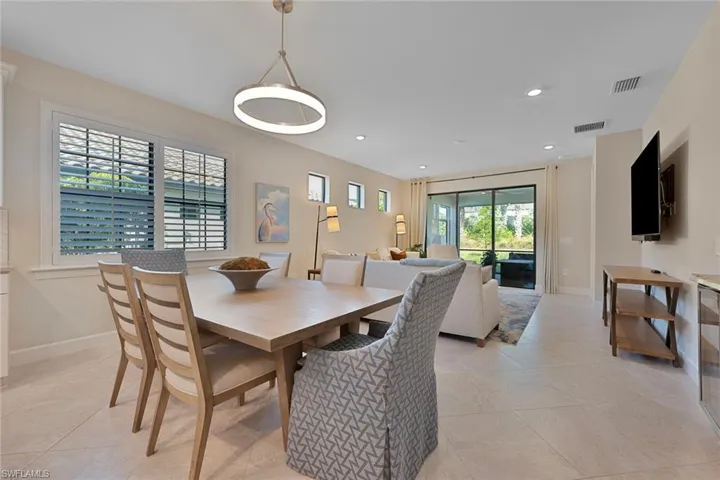 Dining room featuring light tile patterned floors and recessed lighting