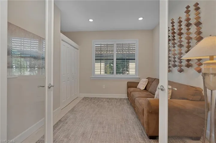Third bedroom with full closet/sitting room featuring recessed lighting and french doors
