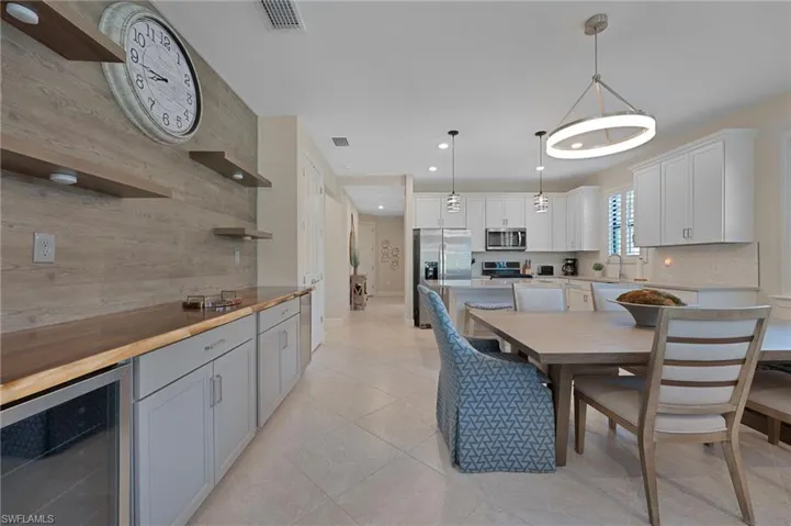 Dining room with beverage coolers, recessed lighting, and light tile patterned floors