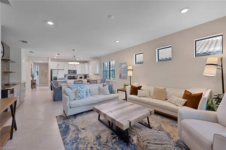 Living area with recessed lighting and light tile patterned floors