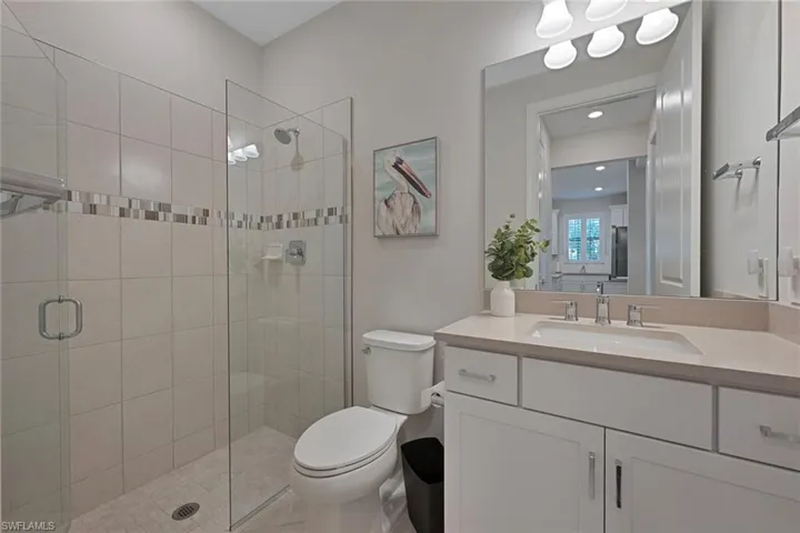 Full bathroom featuring vanity and a stall shower