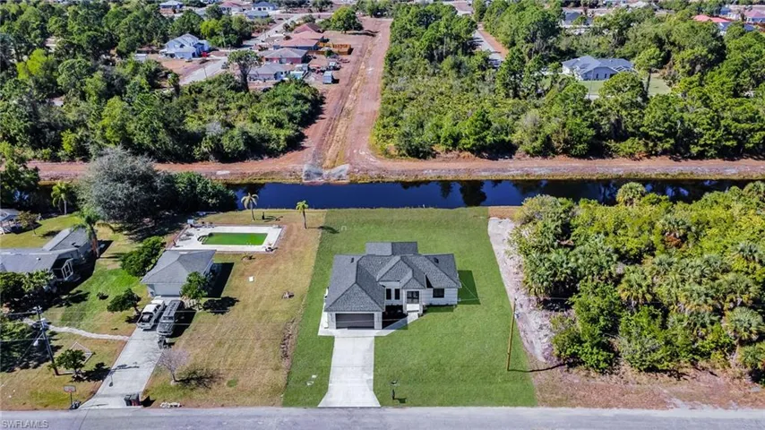Aerial overview of property's location with a nearby body of water and nearby suburban area