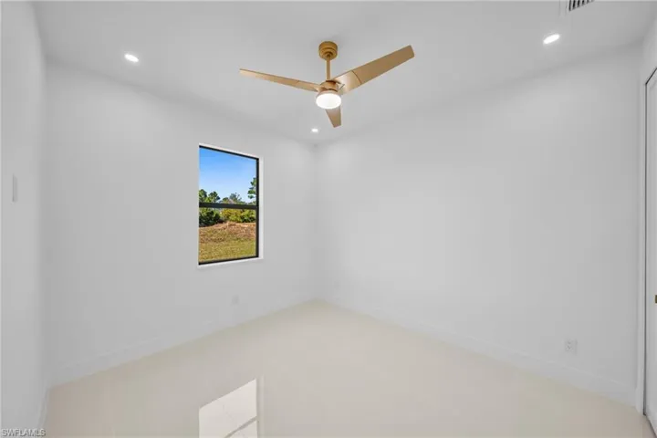 Spare room featuring recessed lighting, ceiling fan, and light tile patterned flooring