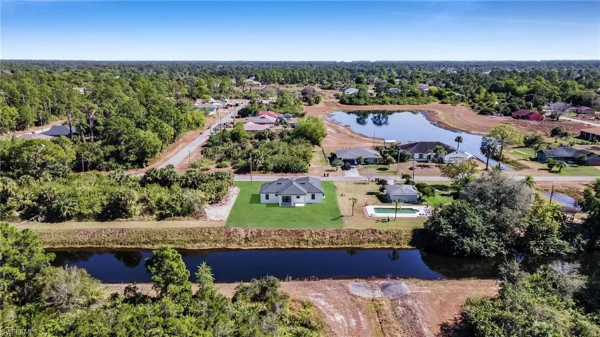 Aerial perspective of suburban area with a large body of water