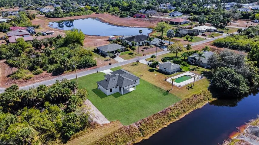 Aerial overview of property's location featuring a nearby body of water and nearby suburban area