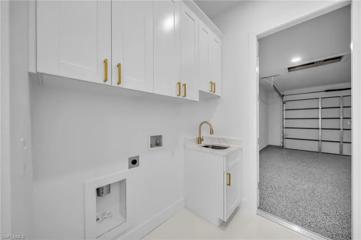 Laundry room featuring cabinet space, washer hookup, and electric dryer hookup
