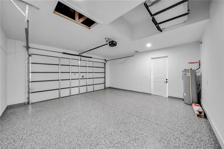 Garage with water heater and baseboards