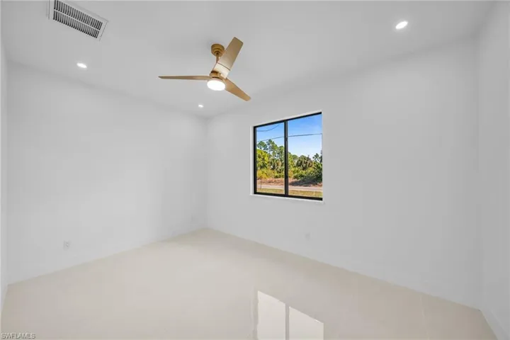 Spare room featuring recessed lighting, a ceiling fan, and light tile patterned flooring
