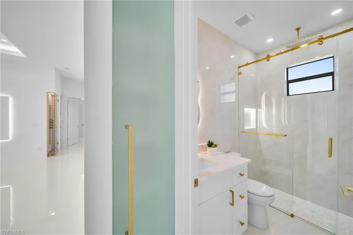 Bathroom with vanity, recessed lighting, a stall shower, and light tile patterned floors