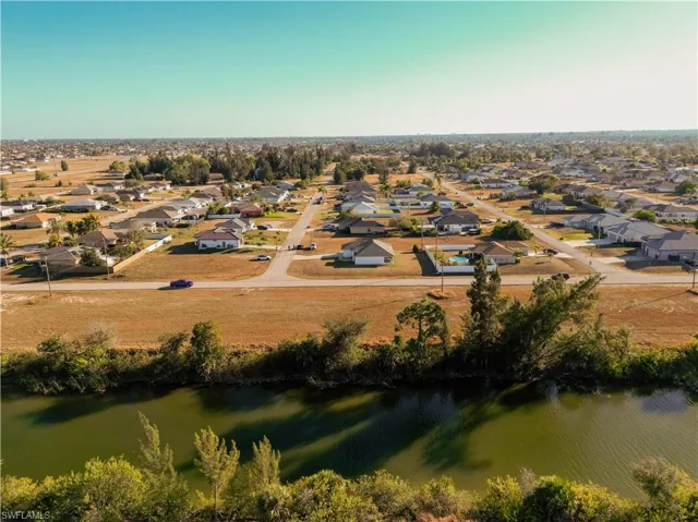 Aerial overview of property's location with nearby suburban area and a large body of water