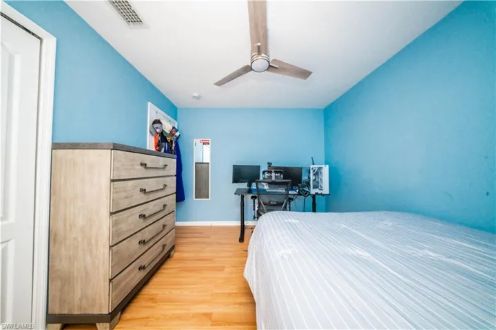 Bedroom with light wood finished floors and ceiling fan
