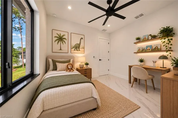 White tile flooring, black ceiling fan, built-in shelving with integrated lighting, wood-finish desk, and large window with black trim
