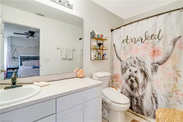 Ensuite bathroom featuring visible vents, toilet, ceiling fan, ensuite bathroom, and vanity