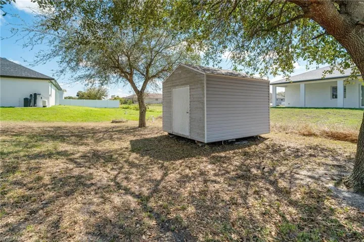 View of shed featuring fence