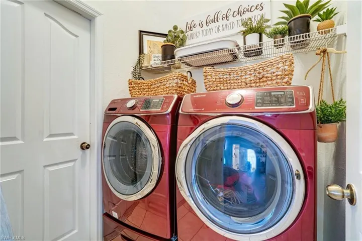 Laundry room featuring laundry area, washer and clothes dryer, and tile patterned floors