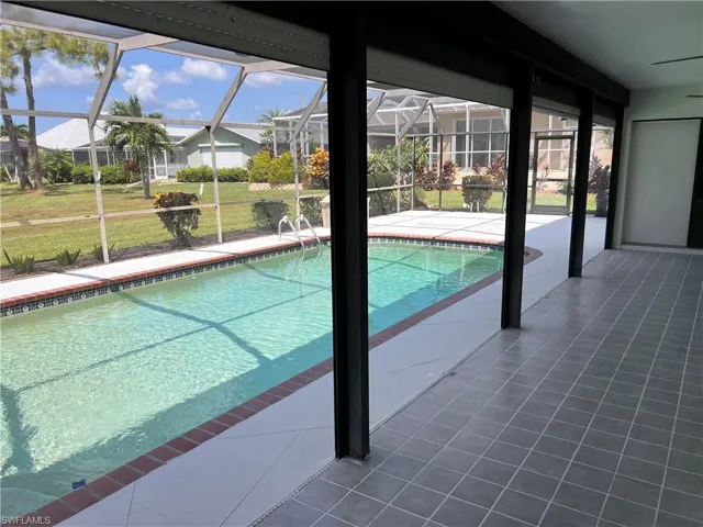 View of pool with a lawn, a lanai, and a patio area