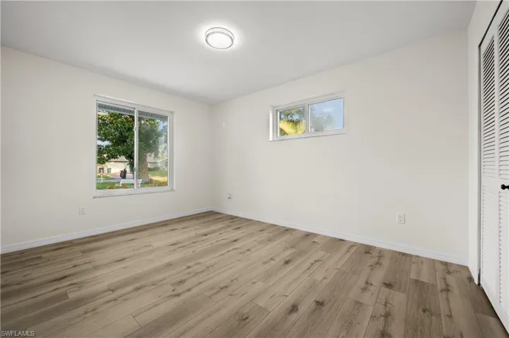 Unfurnished bedroom with a closet and light hardwood / wood-style floors