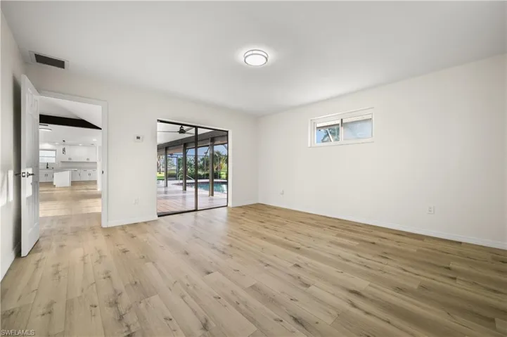 Empty room with ceiling fan and light wood-type flooring