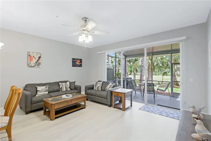 Living room featuring wood-type flooring and ceiling fan