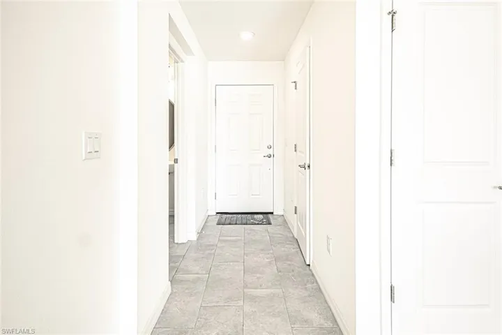 Hall with recessed lighting and baseboards