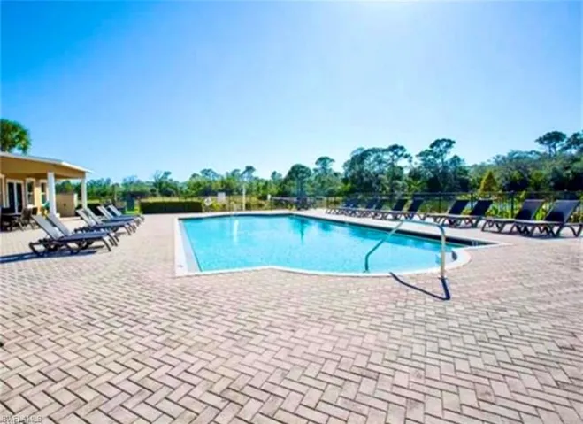 Community pool with a patio