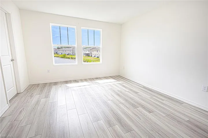 Empty room featuring light wood finished floors and baseboards
