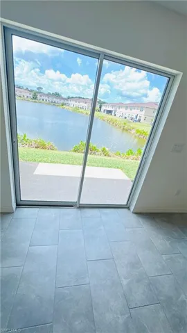Entryway with a water view and baseboards