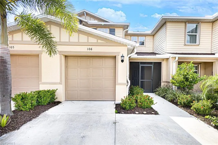 Townhome / multi-family property featuring concrete driveway